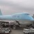 Large blue plane belonging to Korean Air being loaded at an airport